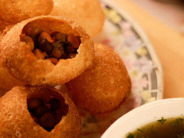 Pani Puri reimagined: the classic gol gappa presented elegantly on a ceramic plate in fine dining style