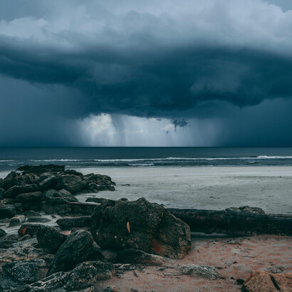 A cyclone swept across the sea, shrouding the horizon in storm clouds and dark weather