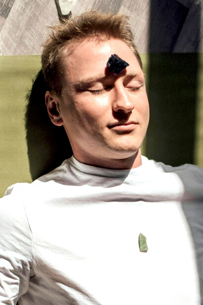 Energy balancing at work—crystal therapy meets mindfulness as a man receives reiki treatment for clarity and grounding