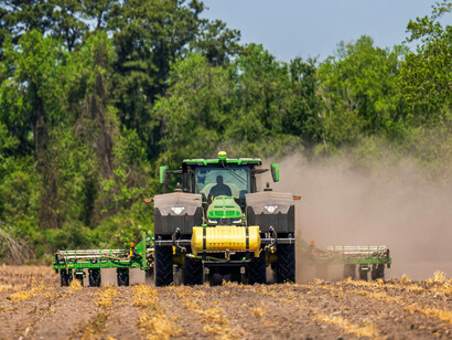 Tractor working the fields, illustrating sustainable, climate-friendly, and technologically advanced smart farming methods