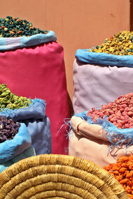 Rows of vibrant Moroccan spices fill the market stalls, offering a rich palette of flavors essential for creating traditional dishes like Rfissa