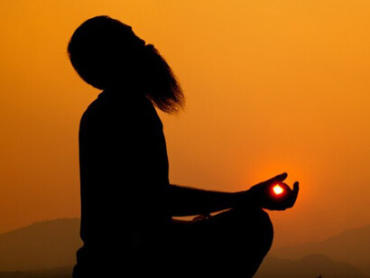 A serene yoga session in the mountains during sunset, capturing the unity of heart and mind, deep mindfulness, intuition, and the subtle movement of invisible energy waves