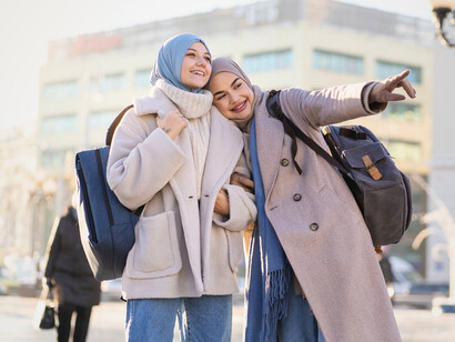 Two women navigating a new destination together, symbolising how educational exchanges encourage openness, understanding, and shared discovery