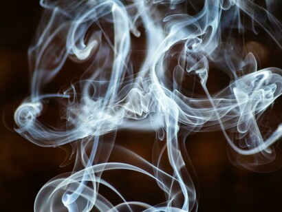 Wisps of smoke ascending, dissolving into the surrounding air