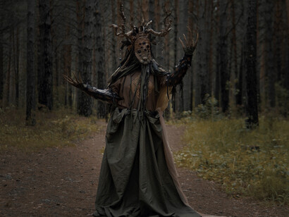 Spooky figure framed by forest darkness, reflecting the shared human response to unseen threats