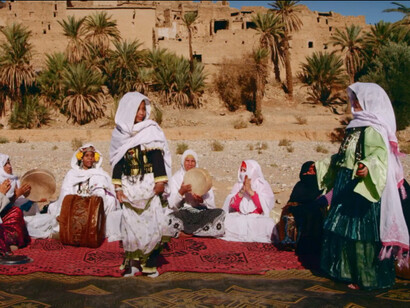 Women partaking in Ahwash, a fundamental element of Amazigh culture, featuring music, dance, poetry, and storytelling