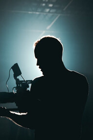 On set with a camera in hand, capturing the magic of film production where AI is the unsung hero behind the scenes, enhancing visual effects and streamlining editing