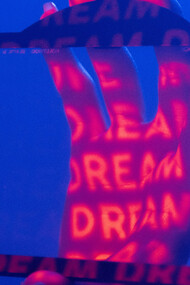 A hand within a frame, word projected into it