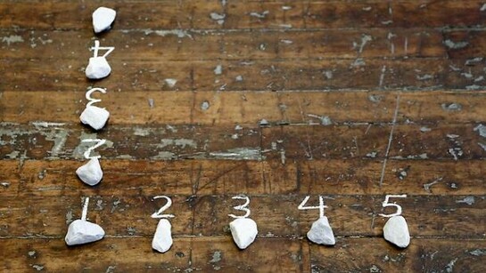 Mel Bochner, 5 Stones / 4 Spaces (Hinge), 1972, stones and chalk on floor, size determined by installation