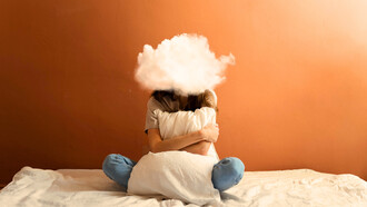 A woman sitting on her bed with a cloud in place of her head, representing the mental fog created by constant overthinking