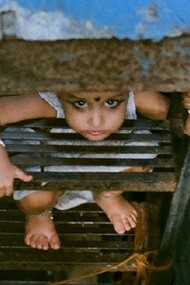 A child and his sad looking across a staircase