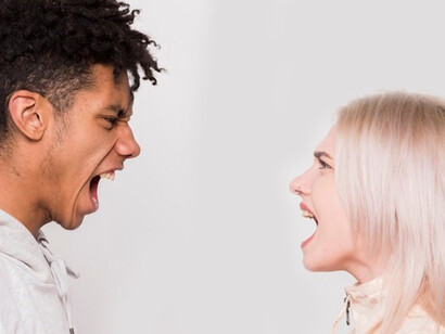 An interracial couple arguing intensely, reflecting stereotypes, unconscious bias, and cultural misunderstandings