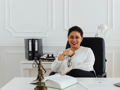 A lawyer sits at her desk in the office, reading through documents