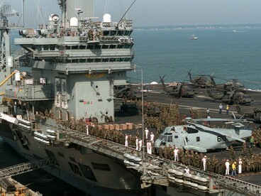 Soldiers from the U.S. Army’s 10th Mountain Division, based at Fort Drum, New York, gather on the flight deck of the nuclear-powered aircraft carrier USS Dwight D. Eisenhower (CVN-69) as it departs for the Caribbean to support Operations Able Vigil and Support Democracy near Haiti
