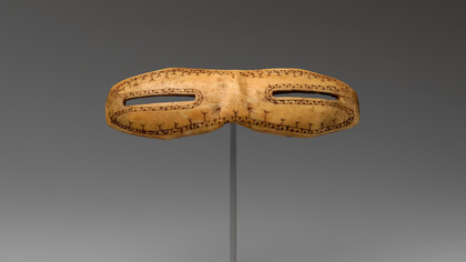 Snow goggles, dating from circa 800–1200, carved from walrus ivory and measuring 1 1/8 × 5 inches (2.9 × 12.7 cm), are part of the American Wing collection at the Metropolitan Museum of Art, USA