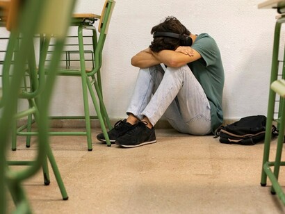 A sleep-deprived student struggling to focus in the classroom