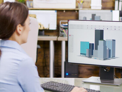 A female architect utilizing Building Information Modeling (BIM) software to create 3D building models, while integrating 3D printing technology into the construction process