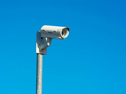 CCTV camera against the blue sky, representing facial recognition technology