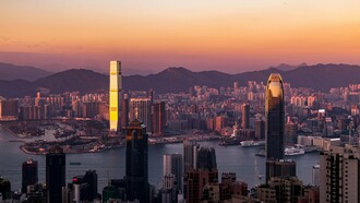 Hong Kong’s towering skyline in the evening light, reflecting the vibrant rhythm of a city that never stops moving
