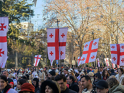 Protesters fill the streets of Georgia’s cities, waving Georgian flags as movement leaders address the crowd through a megaphone