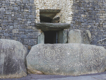 The carved stone located on the rear outer wall of the Newgrange Tomb in Ireland