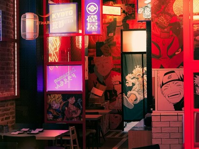 A manga café filled with various drawings, capturing the boom of mature, layered storytelling