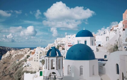 View of Santorini, Greece, with iconic white houses and blue-domed churches