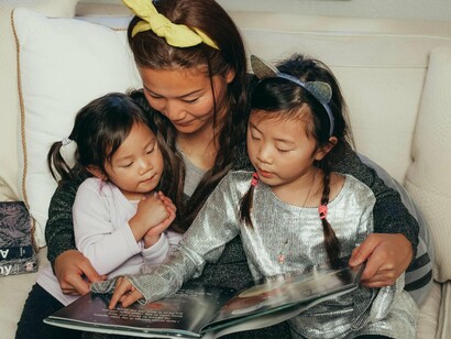A mother reading stories to her children, signifying how it is an important bonding activity and can create lasting memories
