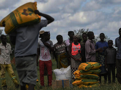 Mozambican locals receive aid from the World Food Programme in Bebedo, Mozambique, on April 8, 2019, as part of humanitarian relief efforts following Cyclone Idai