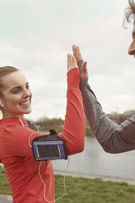 A happy couple celebrating the end of their exercise routine with a high five