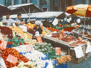 Colorful abundance meets the quiet tension of a market stretched to its limits