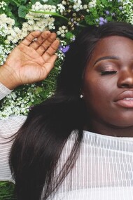 A woman lying on the grass, relaxing, feeling good with herself