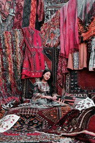 A woman sitting on traditional Turkish carpets in Cappadocia, Turkey—capturing the region’s rich cultural heritage and artisanal craftsmanship