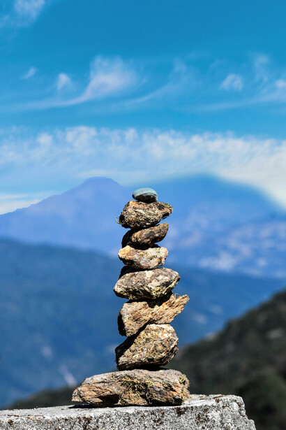 Cairn of stones with a panoramic Himalayan view