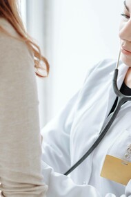 A doctor examining a patient who has an autoimmune disease