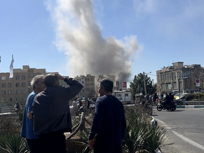 Tehran on the fourth day of war, with missiles and smoke rising over the city, Iran