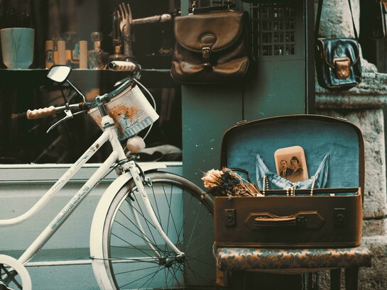 A vintage bicycle rests outside a charming shop, evoking a sense of classic beauty