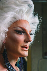 In the spotlight of creativity, the drag queen's eye makeup sparkles with bold colours, reflecting the vibrant spirit of self-expression that defines the art of drag