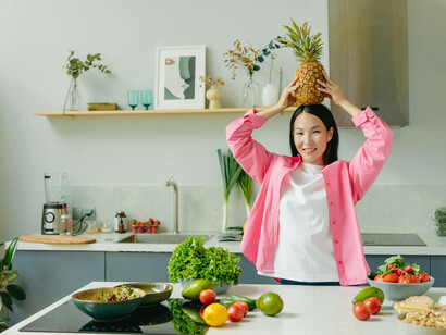 A woman using a blender to prepare healthy food