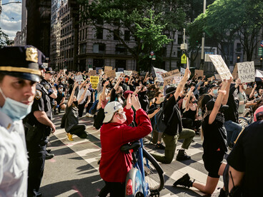 In the heart of New York, a movement of activists raises their voices and arms, demanding justice and human rights