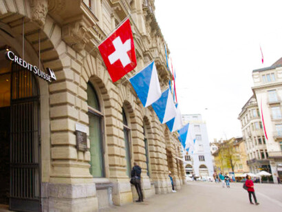 Paradeplatz in Zurich, Switzerland, is adorned with flags, featuring the Credit Suisse headquarters