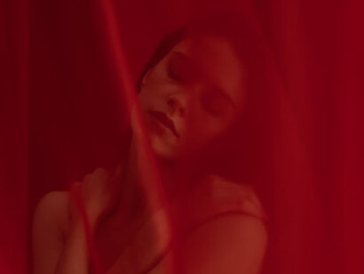 Behind the curtain, she represents the struggles many women face as they navigate the conflicting messages about their bodies and desires