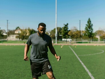 Athlete walks off the field after practice reflecting resilience 