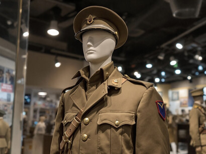 Behind the glass, a military uniform is carefully displayed