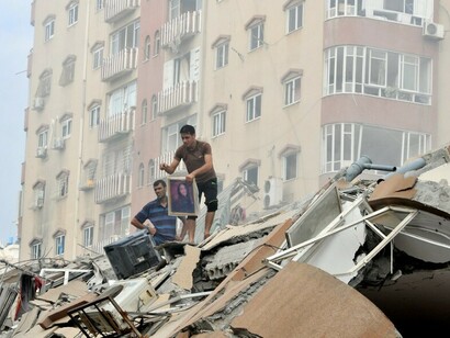 Palestinians search desperately among the rubble of their destroyed houses after Israeli strikes in northern Gaza