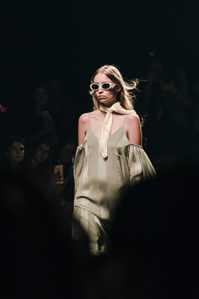 Woman in a white dress and sunglasses, radiating elegance and style