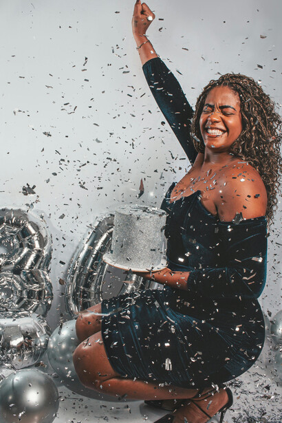Smiling woman holding a birthday cake while celebrating turning 30