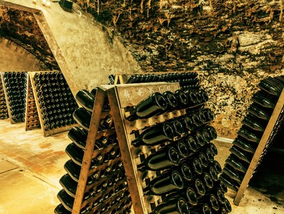 In these ancient stone vaults, still wine slowly transforms into sparkling elegance