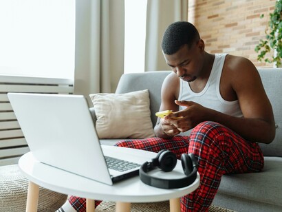 At home alone, a person looks at his phone, reflecting a quiet form of individualism