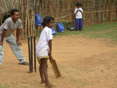 A group of Indian kids enjoying street cricket, a beloved pastime across the country